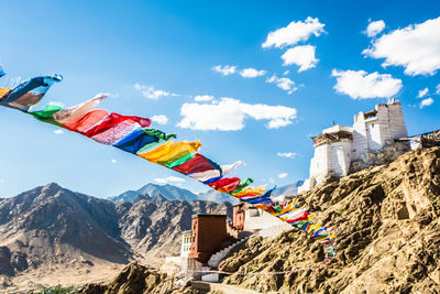 Low angle view of flags against sky