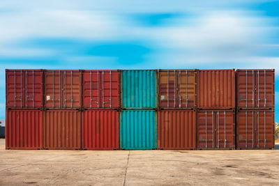 Stack of cargo containers against sky