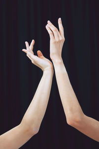 Cropped image of woman against black background