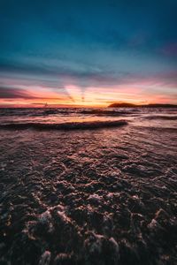 Scenic view of beach against sky during sunset