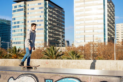 Young skater teen standing on ramp ready to start riding