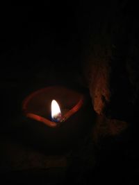 Close-up of illuminated lamp over black background