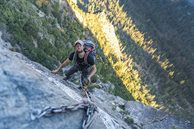 Man looking up doing funny face while jugging rope up el capitan