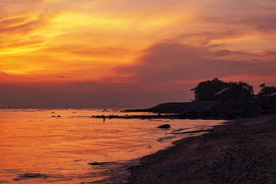 Scenic view of sea against orange sky