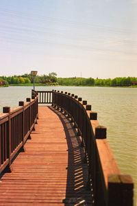 Pier over lake against sky