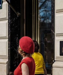 Women walking against glass door