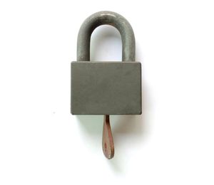 Close-up of padlock against white background