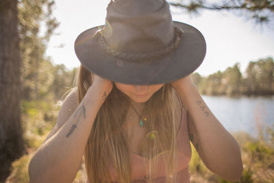 Close-up of young woman against blurred background