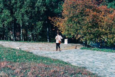 Woman walking on footpath