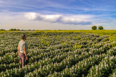 Man standing on field against sky