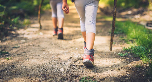 Low section of woman walking on grass