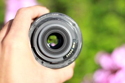 Cropped hand holding camera