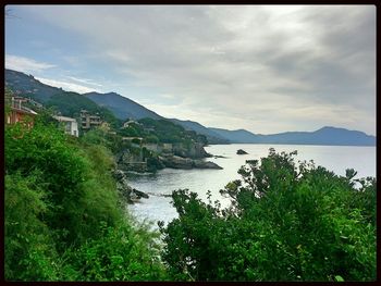 Scenic view of mountains against cloudy sky