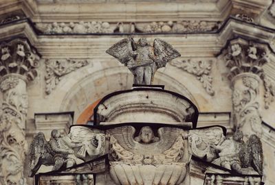 Low angle view of statue against historic building