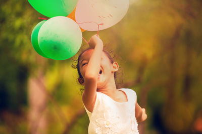 Full length of a girl with balloons