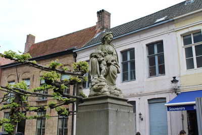 Low angle view of statue against building