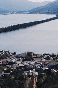 High angle view of townscape by sea against sky