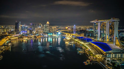 Illuminated marina bay sands against sky at night