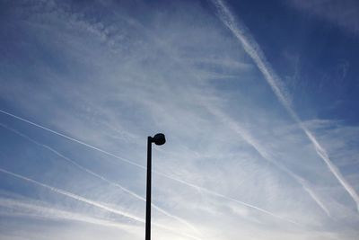 Low angle view of street light against blue sky