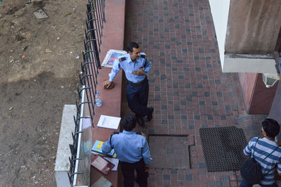 High angle view of people standing against buildings