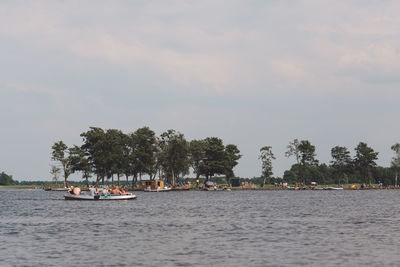 Scenic view of nautical vessels in sea against sky