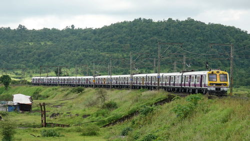 Entire 12 car kasara local train captured at a lush green scenic landscape of kasara.