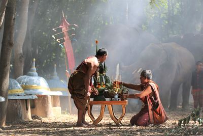 Men praying by table