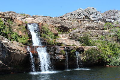 Scenic view of waterfall against clear sky