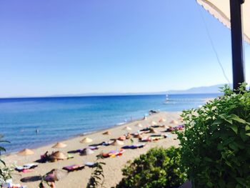 Scenic view of beach against clear blue sky