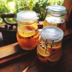 High angle view of fruits in jars on table