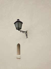 Low angle view of street light mounted on wall