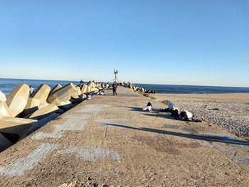 Scenic view of beach against clear blue sky