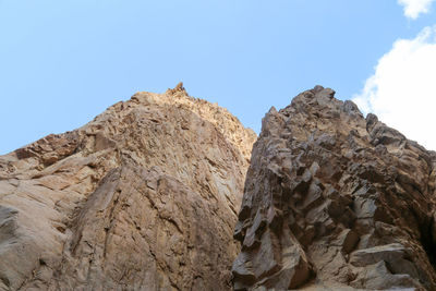 Low angle view of rock formation against sky