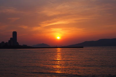 Scenic view of sea against orange sky