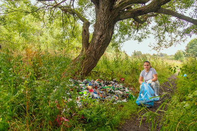 Woman clean up garbage dump in the park. horizontal photo