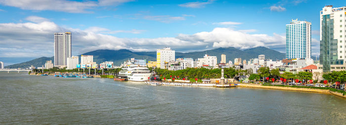 Panoramic view of sea and buildings against sky