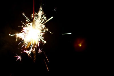 Low angle view of firework display at night