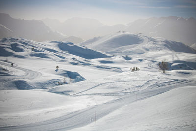 Scenic view of snow covered mountains against sky