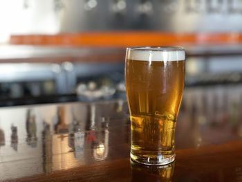 Close-up of beer glass on table