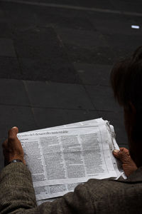 Midsection of woman reading book