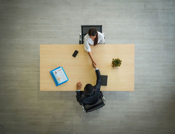 High angle view of man using laptop on table