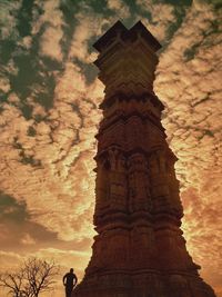 Low angle view of temple against cloudy sky