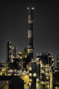 Low angle view of illuminated buildings against clear sky at night