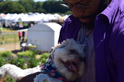 Man with dog sitting outdoors