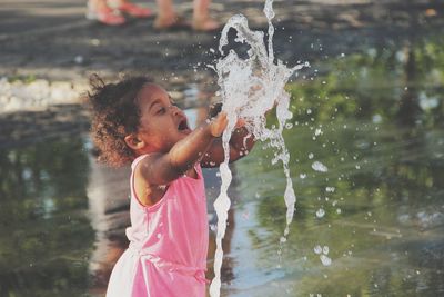 Full length of woman standing in water