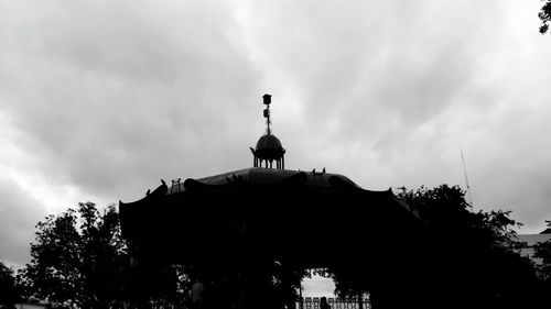 Low angle view of statue against cloudy sky