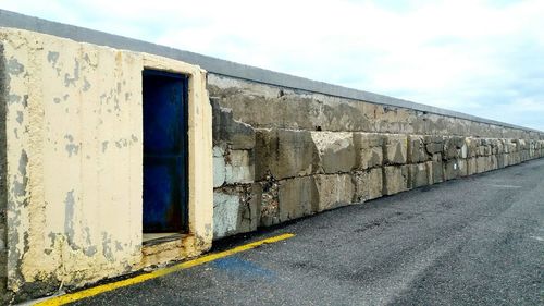 Close-up of brick wall against sky