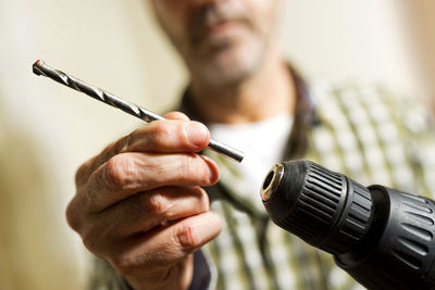 Close-up of man holding work tool