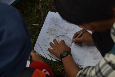 Man drawing on map paper