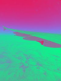 Close-up of multi colored umbrella against blue sky